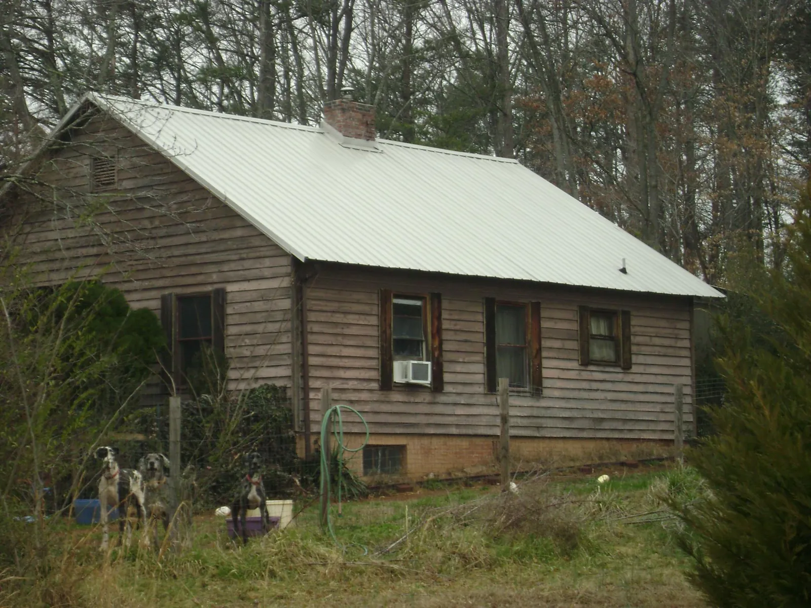 White metal roof on an old wood sided farmhouse, from a Asphalt Shingle Roof Repair job in China